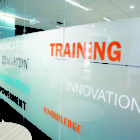 Window signs in an office with graphic designs and lettering.